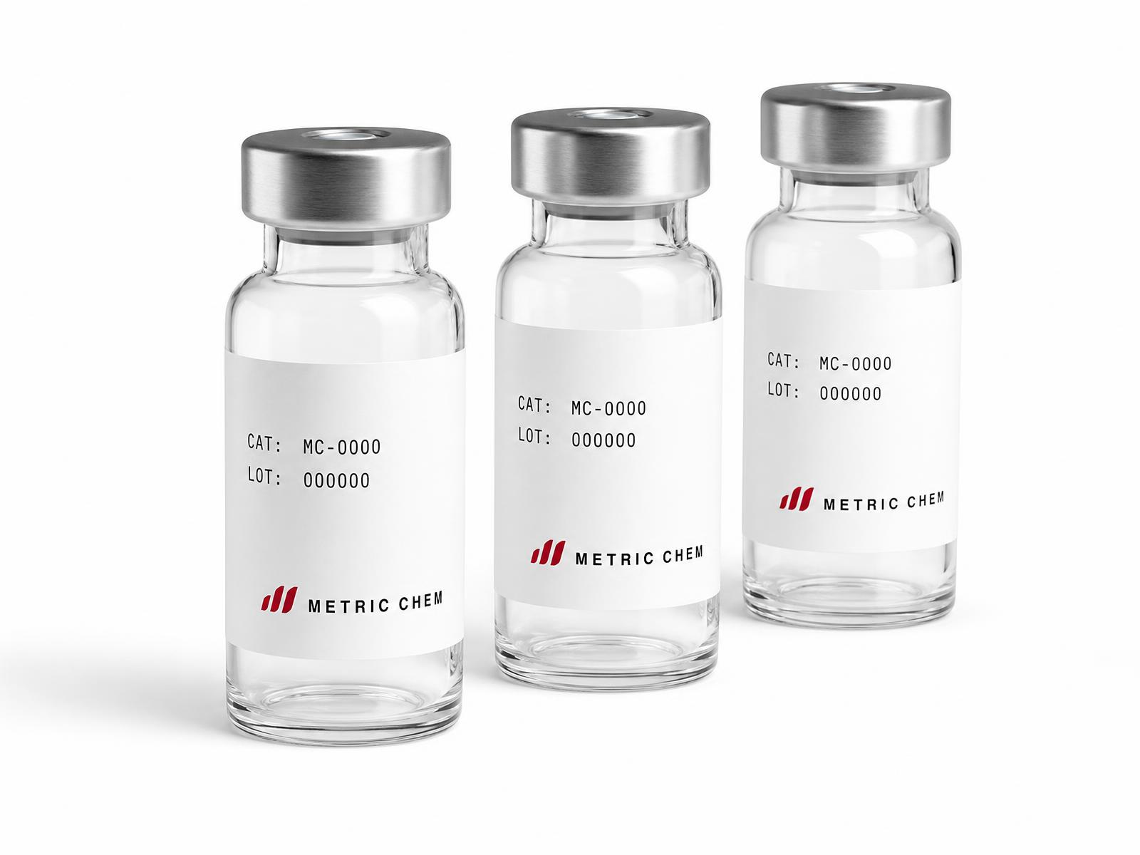 Three Metric Chem laboratory vials with silver crimp caps and lot-marked labels on a white background
